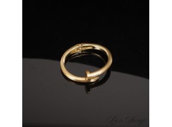 #7 A RECENT AND HIGH QUALITY GOLD TONE BRACELET IN THE SHAPE OF A LARGE NAIL WITH FLEX HINGE