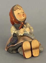 Goebel Hummel Figurine Of A Child Sitting With A Blackbird.