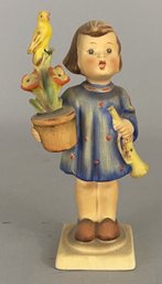 Goebel Hummel Figurine Of A Girl With A Yellow Bird On A Plant