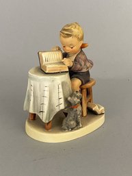 Goebel Hummel Figurine Of A Boy Sitting At Table Reading A Book