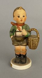 Goebel Hummel Figurine Of A Boy Holding A Basket 'Village Boy'