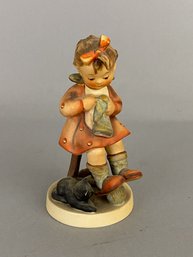 Goebel Hummel Figurine Of A Girl Knitting With A Cat Next To Her