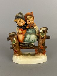 Goebel Hummel Figurine Of Two Children Sitting On A Fence With Birds