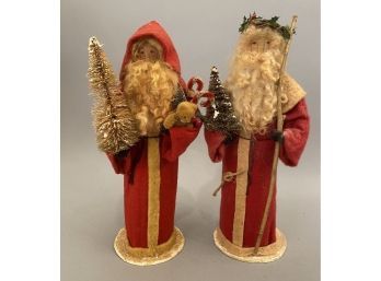 Joni 98 To Handcrafted Santas In Red. Both Holding Christmas Trees