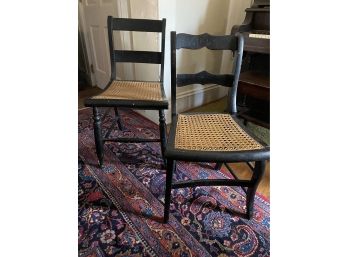Two Black Wood Chairs With Cane Seats
