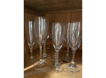 7 Champagne Flutes Of Different Sizes