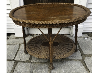 ANTIQUE OVAL WICKER AND OAK TABLE