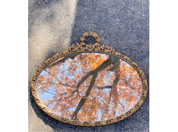 DECORATIVE OVAL MIRROR W RINGED FLORAL CREST