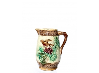 FOOTED MAJOLICA PITCHER W BIRD & FLORAL DECORATION
