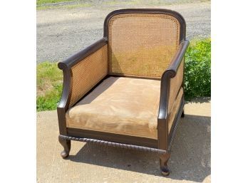 CARVED CANE BACK CLUB CHAIR ON CABRIOLE LEGS