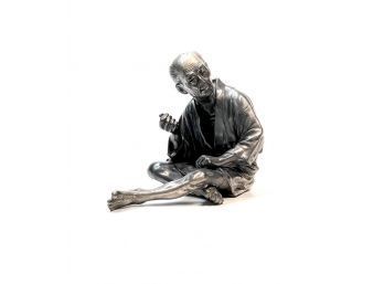 JAPANESE WHITE BRONZE FIGURE OF A SEATED MAN