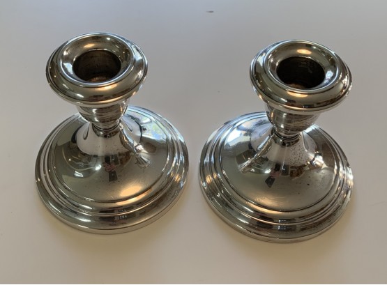 PAIR OF STERLING SILVER WEIGHTED CANDLESTICKS.
