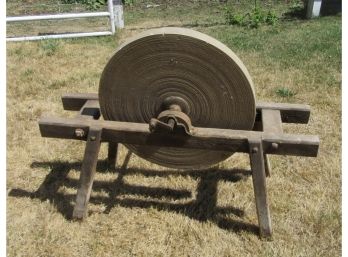 Old Grindstone On Wooden Stand