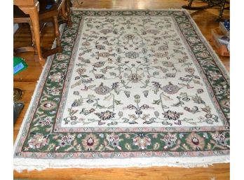 Cream Colored Rug With Green Boarder