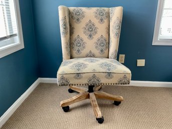 An Upholstered Wingback Swivel Desk Chair