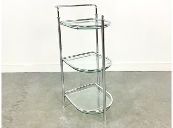 A Chrome And Glass Three Tiered Stand