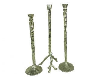 A Trio Of Tall Hammered Metal Candleholders