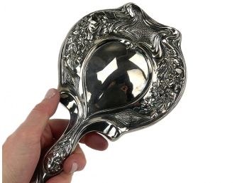 A Vintage High Relief Silverplate Hand Mirror
