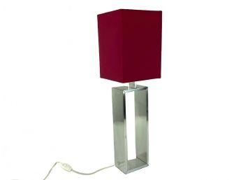 An IKEA Torsbo Table Lamp With Red Shade
