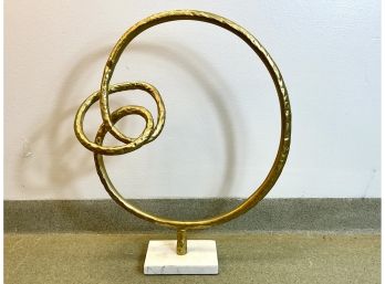 A Gold Painted Metal Sculpture On Stand