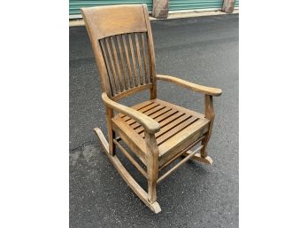 Wooden Rocking Chair Used Outside On A Covered Porch