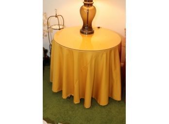 Yellow Cloth Covered Table With Glass Top