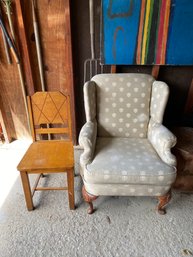 An Upholstered Wing Chair With A Vintage Art Deco Side Chair