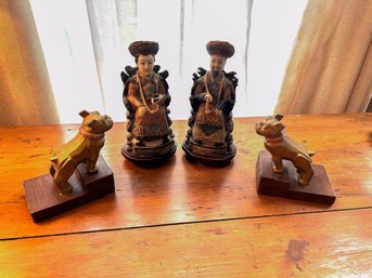 A Grouping Of Figurines Of An Asian Man And Asian Woman With Carved Dog Bookends