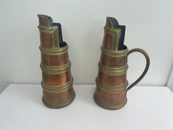A Pair Of Copper And Brass Pitchers