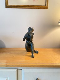 Signed Sculpture Of Man Playing A Musical Instrument.