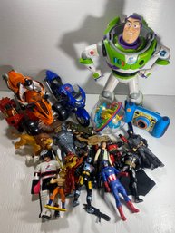 Lot Of Various Action Figures, Motorcycles, Camera, Buzz Lightyear, And Other Various Toys