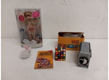 Vintage Assortment Including Bindi Doll, Rubix Cube, Brownie Movie Camera, And More