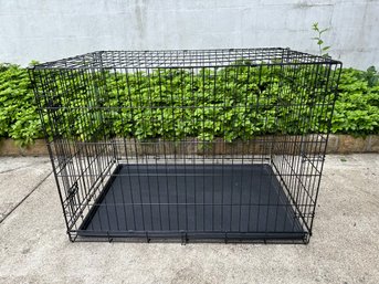 A Large Metal Pet Crate With Liner