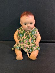 Vintage Composition Baby Doll In A Green Flowered Dress