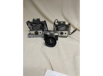 Two Polaroid Land Cameras And Pentax ZX-50 Camera