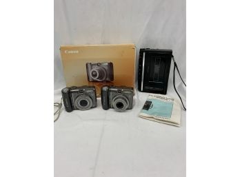 Two Canon Powershot Cameras And A Realistic Mini Cassette Recorder