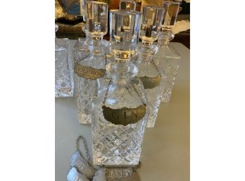 7 CRYSTAL DECANTERS W/9 PEWTER STEIFF BOTTLE TAGS
