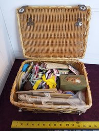 Wicker Basket Full Of Ribbons, Lace, Buttons, And Various Sewing Items