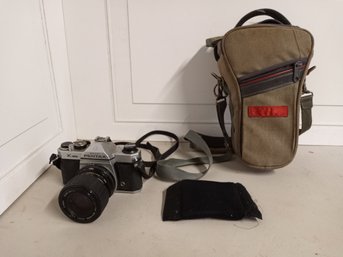 An Asahi Pentax K1000 Camera And A Camera Case