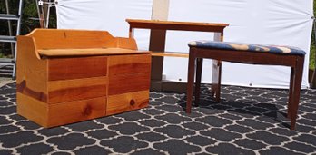 A Cushioned Piano Bench, A Chest And A Table With A Shelf