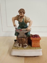 Melody In Motion Figurine, Hand-painted Porcelain Bisque Finish, Depicts A Blacksmith At Work