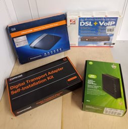 4  Boxes Of Modems, Routers And/or Adapters, All Appear Unused