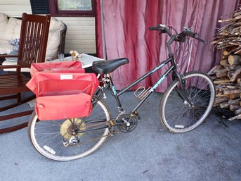 An Antelope Trek Bike (black) And LL Bean Brand Bike Carrying Satchels (red)