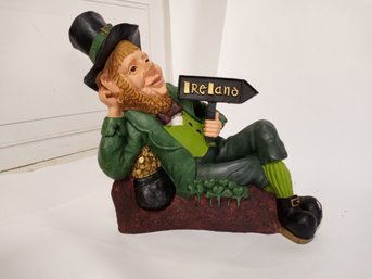Leprechaun Figurine, Reclining, With A Sign That Says 'Ireland'