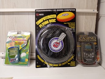 3 Powered Games And Toys. Includes Golf Champion, Excalibur Casino Calculator & Computerized Flying Disk