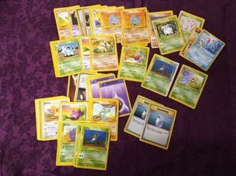 A Small Assortment Of Pokemon Cards.
