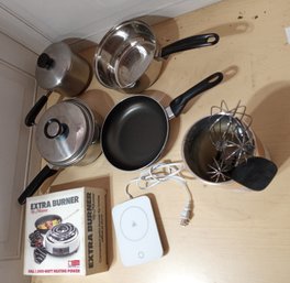 Assortment Of Pots And Pans, Some Kitchen Gadgets And Two Warming Devices.