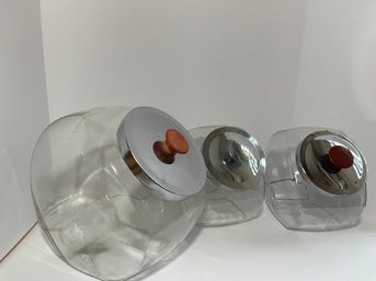 Three Glass Lidded Canisters