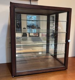 Display Case With Glass Shelves And Mirrored Back