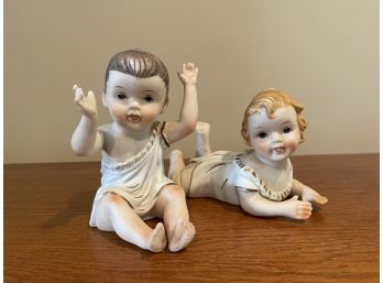 Pair Of Porcelain Piano Baby Figurines